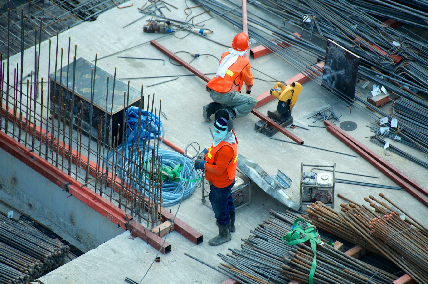 Construction workers coordinating work on a reinforced concrete structure